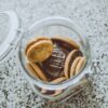 ガラス瓶に保存されたクッキー。お菓子の買い置きを容器で管理するイメージ